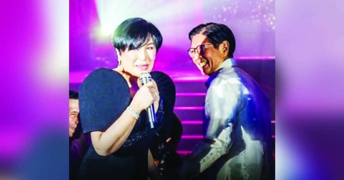 Sharon jokes copy_superimposed_compressed Megastar Sharon Cuneta playfully joked with Ferdinand “Bongbong” Marcos Jr. about his vice presidential choice during the 2022 elections while hosting a gala event in Intramuros, Manila. She shared lighthearted banter with the President and First Lady Liza Araneta-Marcos before performing a requested song.