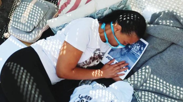 Venezuela A woman lies on the ground outside Zona 7 detention center in Caracas, Venezuela. Many of those protesting outside the center are wearing T-shirts reading “free all the political prisoners” and carrying pictures of their jailed relatives. EPA