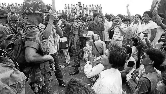 edsa.JPG_resized_compressed This file photo shows a scene during the Edsa People Power Revolution in February 1986. Nuns are seen praying with protesters as government solders look on. INQUIRER FILE PHOTO
