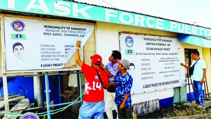 ime defensor epal copy_compressed_compressed ANTI-EPAL COMPLIANCE. Personnel of the local government unit of Dumangas, Iloilo remove a tarpaulin bearing the name and image of Mayor Braeden John Biron from a government-funded project, following the mayor’s order enforcing the anti-epal policy and directing the immediate removal of personal names, images, and markings of public officials from public projects. PHOTO FROM THE MUNICIPALITY OF DUMANGAS FACEBOOK
