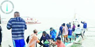 Passengers are assisted ashore after being rescued from a capsized motorized banca off Barangay Buenavista, Carles, Iloilo, following rough sea conditions while en route to Gigantes Island. All 17 passengers and crew members were safely brought to Bancal Wharf and later checked by health personnel. PHILIPPINE COAST GUARD PHOTO