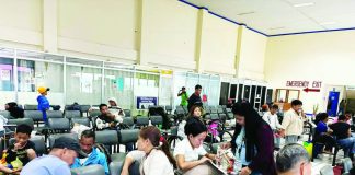 People wait at a ferry terminal in Iloilo City after sea trips were suspended due to the impending landfall of Tropical Storm “Basyang”, leaving at least 62 travelers unable to leave. The suspension followed the raising of Tropical Cyclone Wind Signal No. 1 over Western Visayas. Photos from the Facebook page of Raisa Treñas