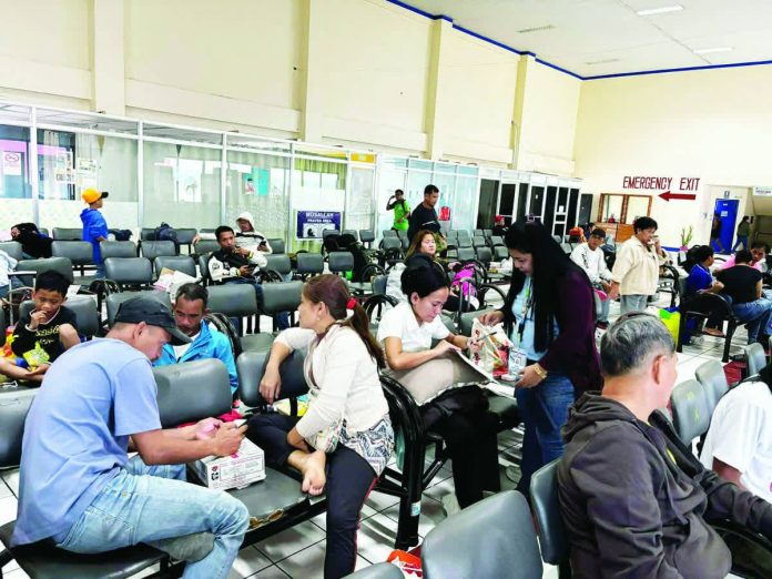 People wait at a ferry terminal in Iloilo City after sea trips were suspended due to the impending landfall of Tropical Storm “Basyang”, leaving at least 62 travelers unable to leave. The suspension followed the raising of Tropical Cyclone Wind Signal No. 1 over Western Visayas. Photos from the Facebook page of Raisa Treñas