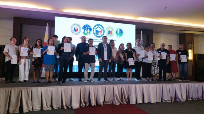 HOUSING SECURITY MILESTONE. Beneficiaries from the Telecom Compound in Barangay Quintin Salas, Jaro, Iloilo City pose with their Certificates of Entitlement during the awarding ceremony of the Presidential Proclamation No. 1538 socialized housing project on February 4, led by the Department of Human Settlements and Urban Development with city officials. NELJOY GALIGAO/PN
