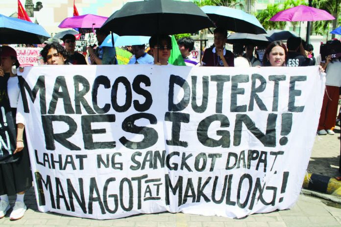 neljoy_EDSA1_copy_resized_compressed Youth protesters hold a bold banner reading “Marcos Duterte Resign” during the EDSA@40 prayer rally in Iloilo City on February 25, 2026, as demonstrators call for accountability and an end to corruption. AJ PALCULLO/PN