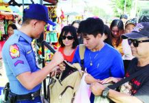 Jaro’s annual Candelaria fiesta ends incident-free – ICPO A police personnel inspects bags of people entering the Jaro Metropolitan Cathedral during the February 2 Feast of Nuestra Señora de la Candelaria, ensuring the safety of devotees and the orderly flow of the celebration. AJ PALCULLO/PN