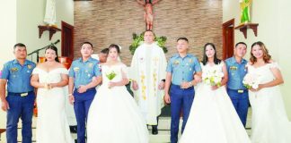 Four police couples exchanged vows during a mass wedding ceremony officiated by Police Brigadier General Jaime C. Seriña III at Saint Michael the Archangel Chapel inside Camp Alfredo M. Montelibano Sr. in Bacolod City on February 20. PRO-NIR PHOTO