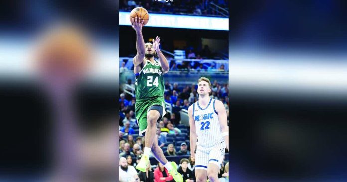 sports Thomas_superimposed_compressed Milwaukee Bucks guard Cameron Thomas soars for a layup. AP