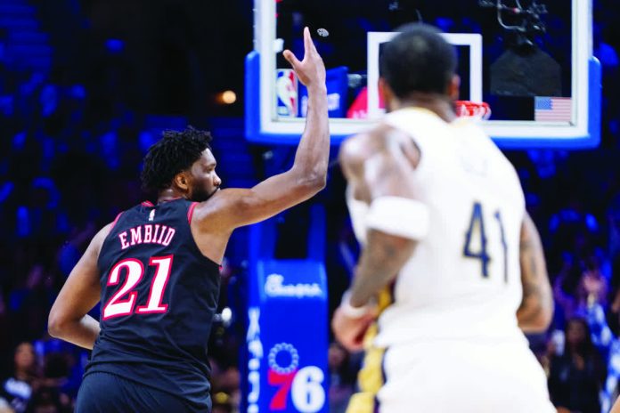 sports_Imbiid_resized_compressed Philadelphia 76ers center Joel Embiid gestures after making a three-pointer against New Orleans Pelicans. AP