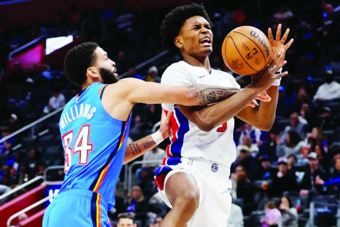 sports_NBA_copy_resized_compressed Detroit Pistons' Ausar Thompson was hacked by the defense of Oklahoma City Thunder's Kenrich Williams. USA TODAY PHOTO