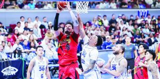 San Miguel Beermen center June Mar Fajardo scores inside against the defense of TNT Tropang 5G’s Henry Galinato Jr. PBA PHOTO