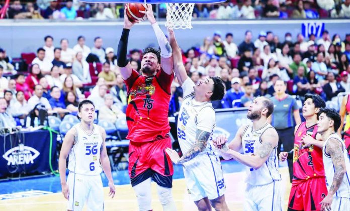San Miguel Beermen center June Mar Fajardo scores inside against the defense of TNT Tropang 5G’s Henry Galinato Jr. PBA PHOTO