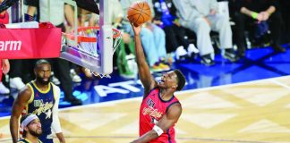 USA Stars guard Anthony Edwards splits the defense of USA Stripes for a layup. AP