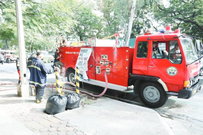 Firemen wait for their truck to be filled with water from a fire hydrant along Visayas Avenue in Quezon City. March is declared as Fire Prevention Month" under Proclamation 115-A signed by former President Ferdinand Marcos. PNA