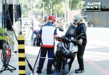 A pump attendant refills the fuel tank of a motorcycle at a gas station in Paco, Manila. The measure granting President Ferdinand Marcos Jr. emergency powers to suspend or reduce fuel excise taxes is now headed to Malacañang for his signature, after the House of Representatives adopted the Senate’s version of the bill, officially bypassing the bicameral conference committee. PNA