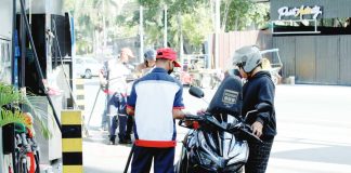 A pump attendant refills the fuel tank of a motorcycle at a gas station in Paco, Manila. The measure granting President Ferdinand Marcos Jr. emergency powers to suspend or reduce fuel excise taxes is now headed to Malacañang for his signature, after the House of Representatives adopted the Senate’s version of the bill, officially bypassing the bicameral conference committee. PNA