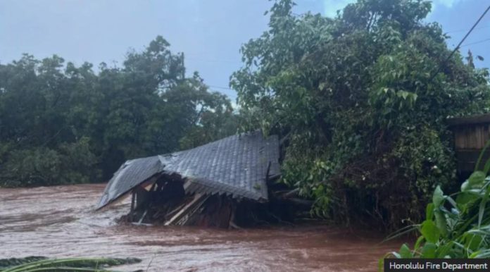 Hawaii A HOUSES collapses in high muddy floodwaters in Hawaii. Honolulu Fire Department photo
