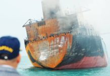 Daylight reveals a damaged tanker off the Iraqi coast after a missile strike by Iran. BBC