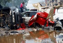 Heavy rains and flooding kills at least 23 in Nairobi A man looks through the wreckage of private vehicles destroyed following heavy rainfall in the Grogan area of Nairobi, Kenya. REUTERS