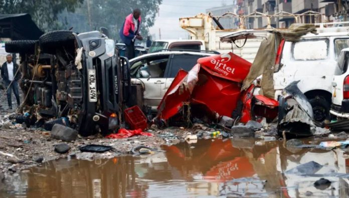 Kenya A man looks through the wreckage of private vehicles destroyed following heavy rainfall in the Grogan area of Nairobi, Kenya. REUTERS