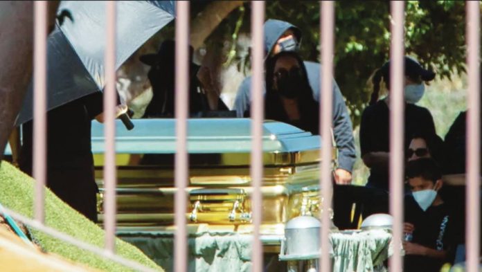 Mexico Mourners - some of them wearing surgical masks - look on as a gold-colored casket containing the body of cartel leader Nemesio Oseguera Cervantes, known as "El Mencho," is displayed during his funeral at the Recinto de la Paz cemetery in Zapopan, Mexico, on March 2, 2026. REUTERS
