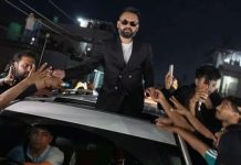 Nepal elects rapper as prime minister Balendra Shah standing out of a car’s sunroof as he takes supporters’ hands who are gathered around the car. He is celebrating with supporters after defeating Nepalese Prime Minister Sharma KP Oli. REUTERS