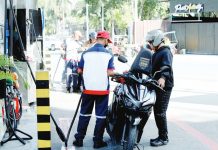 A pump attendant refills the fuel tank of a motorcycle at a gas station in Paco, Manila. The country continues to import crude oil for local refining, a strategy that helps manage fuel costs compared to importing finished petroleum products.