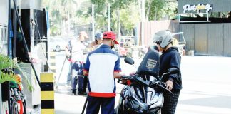A pump attendant refills the fuel tank of a motorcycle at a gas station in Paco, Manila. The country continues to import crude oil for local refining, a strategy that helps manage fuel costs compared to importing finished petroleum products.
