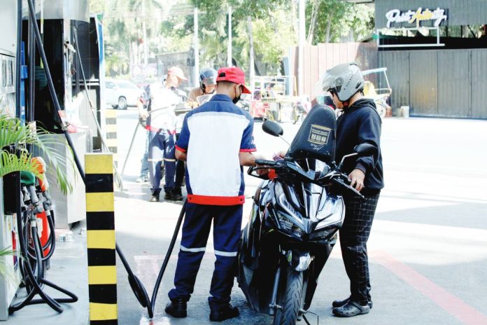 PH oil supply copy A pump attendant refills the fuel tank of a motorcycle at a gas station in Paco, Manila. The country continues to import crude oil for local refining, a strategy that helps manage fuel costs compared to importing finished petroleum products.