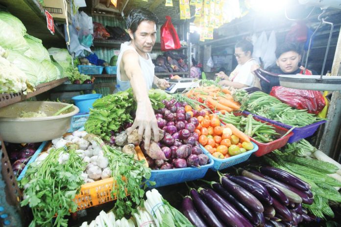 Pulse Asia copy Fresh vegetables fill a stall at Paco Public Market in Manila. Filipinos want the government to focus on bringing down food prices, according to the latest Pulse Asia survey. PNA