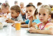 Ukrainian children from an orphanage in the Donetsk region, eat a meal at a camp in Zolotaya Kosa, the settlement on the Sea of Azov, Rostov region, southwestern Russia. AP
