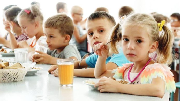 Ukrainian children from an orphanage in the Donetsk region, eat a meal at a camp in Zolotaya Kosa, the settlement on the Sea of Azov, Rostov region, southwestern Russia. AP