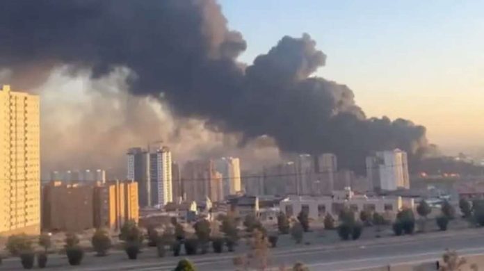Smoke rises above Tehran, as seen in social media footage. The United States of America and Israel step up airstrikes against Iran. BBC