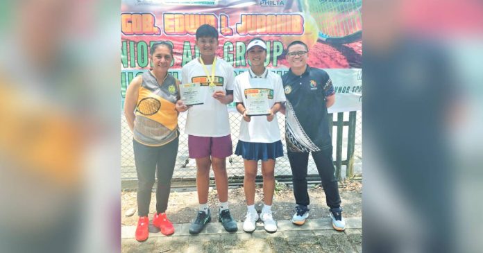 bugna Kathlyn Bugna and Kresthan Belacas display their trophies after delivering impressive performances in the Gov. Jubahib junior tennis tournament. CONTRIBUTED PHOTO
