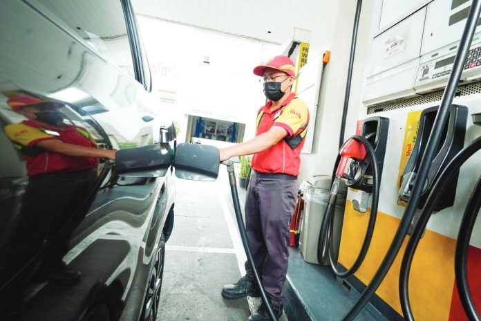 energy emergency copy A fuel station attendant fills up a vehicle at a gas station along Timog Avenue in Quezon City. Under Executive Order 110, the Marcos administration activated a coordinated national framework aimed at securing fuel supply, stabilizing prices, and ensuring uninterrupted delivery of essential services amid rising risks in the global energy market. PNA