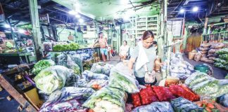 A vendor inspects newly delivered vegetables at a market in Quezon City. The Philippines will remain food secure despite the ongoing tension in the Middle East because of sufficient supply of agricultural commodities, particularly rice, the Department of Agriculture says. PNA