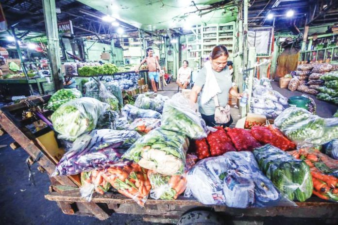 firms hold line copy A vendor inspects newly delivered vegetables at a market in Quezon City. The Philippines will remain food secure despite the ongoing tension in the Middle East because of sufficient supply of agricultural commodities, particularly rice, the Department of Agriculture says. PNA
