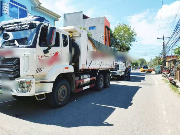neljoy_quarry_(1)_copy_resized Dump trucks suspected of transporting illegally quarried materials are intercepted and impounded by police during coordinated enforcement operations in Iloilo province on Feb. 28, 2026. Authorities seized nine trucks. ILOILO POLICE PROVINCIAL OFFICE PHOTO