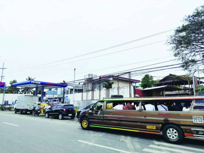 Vehicles line up at the Petron gasoline station in Mali-ao, Pavia, Iloilo, on Monday morning, March 9. Consumers are bracing for a steep climb in fuel prices beginning March 10 amid the escalating geopolitical tensions involving Israel, the United States, and Iran. NELJOY GALIGAO/PN