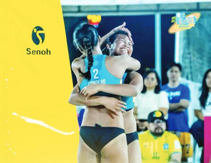 sports Alas copy Honey Grace Cordero and Vilmarie Toos of National University celebrate after clinching the women’s title in the Beach Volleyball Republic Nuvali Open.