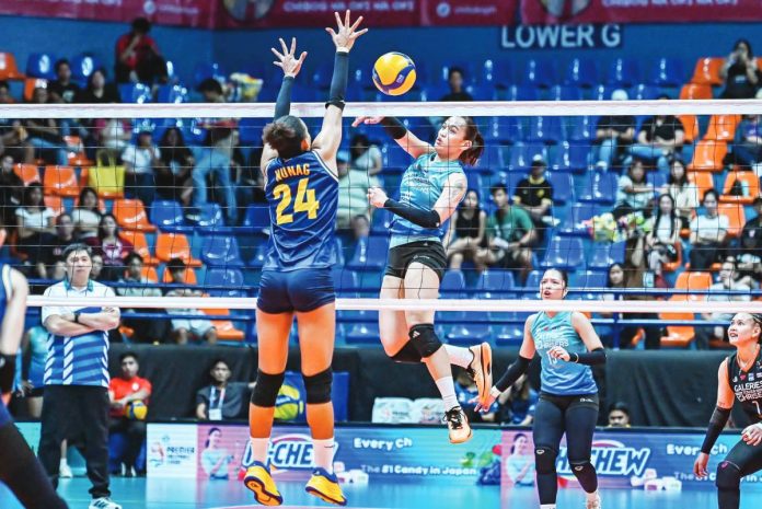 Jean Asis of Galeries Tower Highrisers attempts to score against Cherry Nunag of Capital1 Solar Energy Solar Spikers. PVL PHOTO