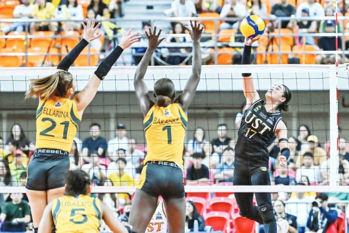 sports Tig copy Angeline Poyos of UST attacks against the defense of Faida Bakanke of FEU. UAAP PHOTO