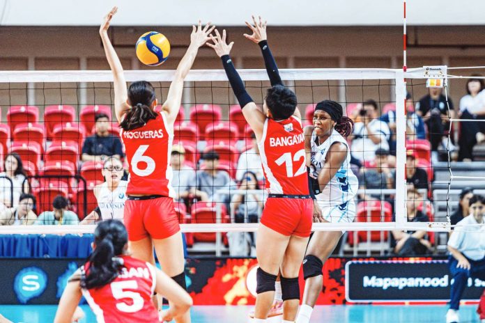 Adamson University Lady Falcons’ Frances Mordi scores against the defense of University of the East Lady Warriors’ Khy Cepada. UAAP PHOTO