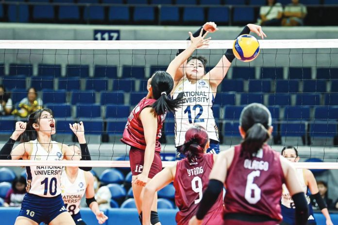 sports UAAP Sam Cantada of National University Lady Bulldogs tries to convert against the defense of University of the Philippines Fighting Maroons. UAAP PHOTO