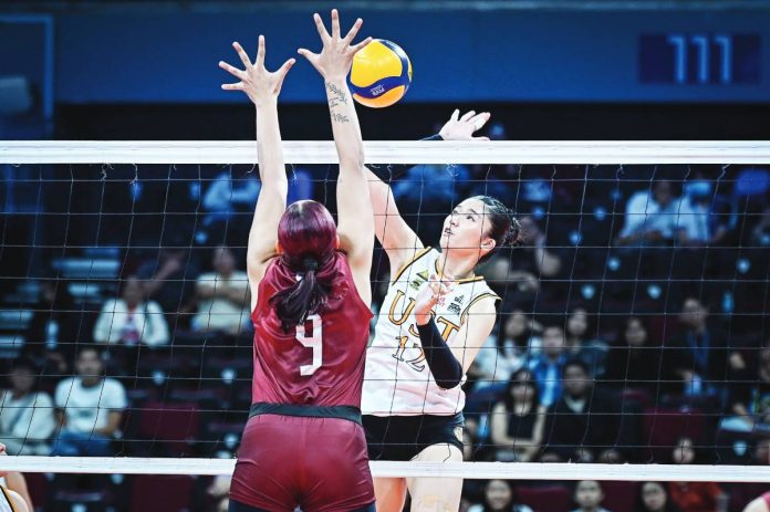 sports UST University of Santo Tomas Golden Tigresses’ Lianne Penuliar scores against the defense of Niña Ytang of University of the Philippines Fighting Maroons. UAAP PHOTO