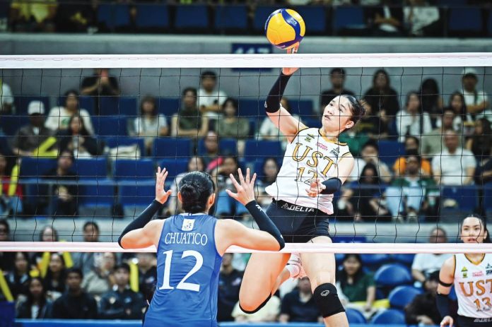 sports UST UAAP University of Santo Tomas Golden Tigresses rookie Lianne Penuliar attempts a drop ball over Ateneo de Manila University Blue Eagles’ Jihan Chuatico. UAAP Photo