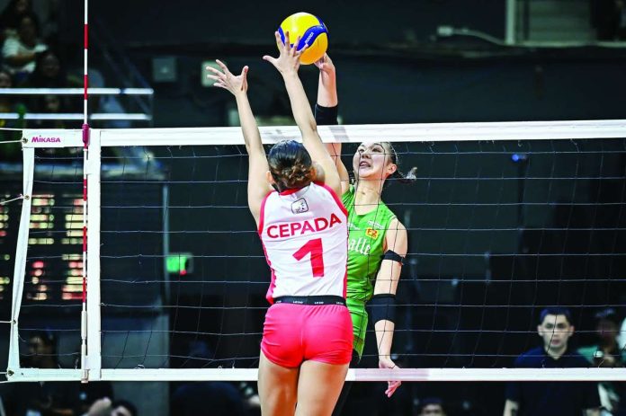sports_DLSU_compressed_resized Shevana Laput of the De La Salle University Lady Spikers scores against the defense of Khy Cepada of the University of the East Lady Warriors during their UAAP Season 88 women’s volleyball match at the Smart Araneta Coliseum. UAAP PHOTO