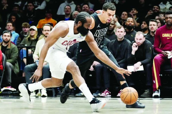 sports_Harden_compressed_resized Cleveland Cavaliers guard James Harden aims for the ball while Brooklyn Nets forward Michael Porter Jr. looks on. AP