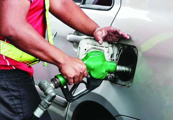 staggered_hikes_copy_compressed_resized A gasoline attendant fills up a vehicle at a petroleum station in Quezon City on March 2, 2026. Motorists are paying more for petroleum products this week following a major price hike on March 3 amid the strikes between the United States and Iran. INQUIRER PHOTO / GRIG C. MONTEGRANDE