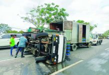 A delivery truck lies on its side after overturning on C1 Road in Barangay Tacas, Jaro, Iloilo City, on Monday morning, March 2, 2026, causing bottles to break and scatter. AJ PALCULLO/PN